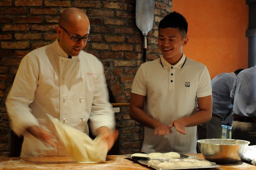 Chef Barbasso showing Jasper of Six & Seven how to make pizza