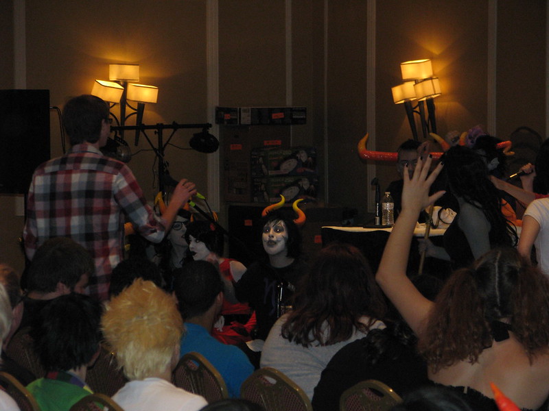 I take the mic to ask the giant panel of Homestuck cosplayers my question. (Photo Credit: Ink)