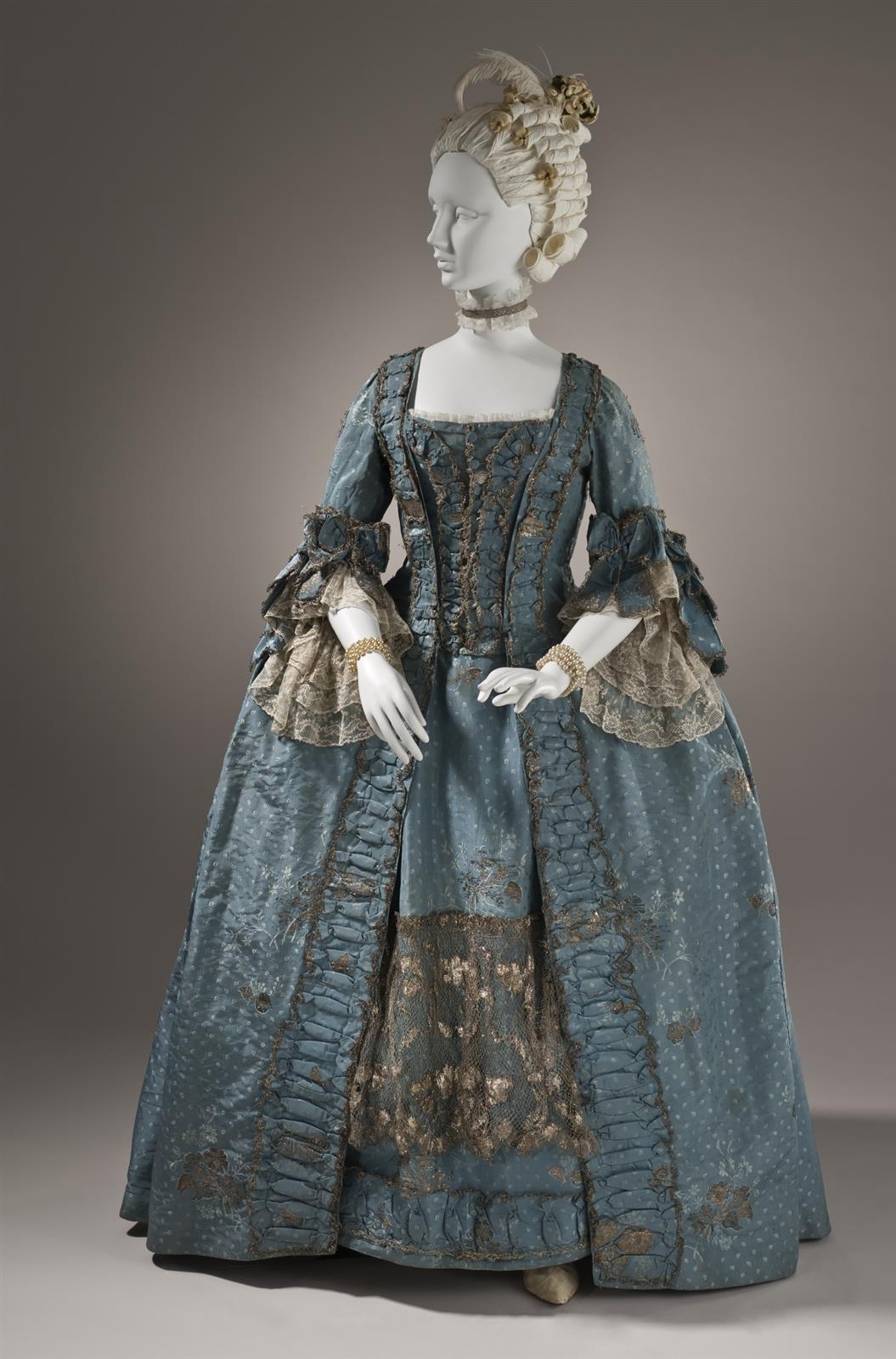 1765. Woman's Dress and Petticoat (Robe à la française). Silk plain weave (faille) with silk and metallic-thread supplementary-weft patterning, and metallic lace. LACMA
