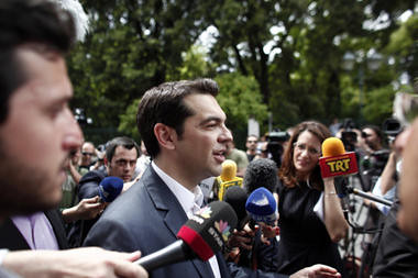 Alexis Tsipras, head of the Radical Left Coalition (SYRIZA) exits the Presidential Palace after his meeting with Greek President Karolos Papoulias, to formally take the mandate to form a coalition government in Athens, Tuesday, May 8. by Pan-African News Wire File Photos