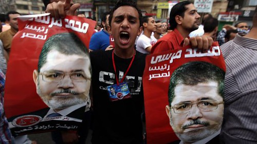 Mohamed Morsi of the Freedom and Justice Party (FJP) which is allied with the Muslim Brotherhood appears on campaign posters throughout Cairo. The so-called independent Ahmed Shafiq, who is backed by the army, has claimed victory. by Pan-African News Wire File Photos