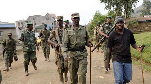 Col. Sultani Makenga of M23 with stick in middle of photograph. The M23 are defectors from the Democratic Republic of Congo army. They have seized several towns in the East. by Pan-African News Wire File Photos