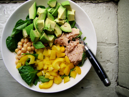 green salad with tuna, chickpeas, avocado, and yellow bell pepper