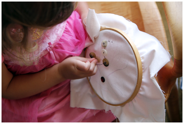 A quiet moment: our four year old working on her sewing project