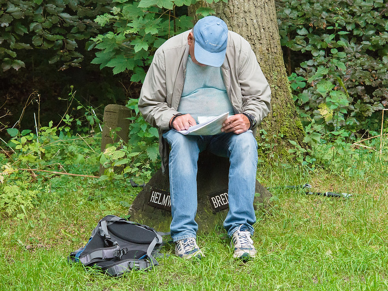 Male Hiker Studying A Map While Resting