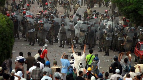 Egyptian riot police clash with demonsrators in Cairo on May 4, 2012. Over a dozen people have been killed since May 2 leading up to the presidential elections. by Pan-African News Wire File Photos