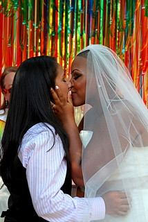 two women kissing at a wedding ceremony