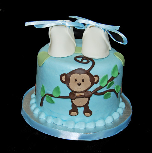 blue green and brown baby shower cupacke tower with monkey hanging from branch