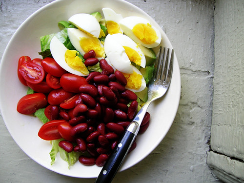 green salad with eggs, kidney beans, and tomatoes