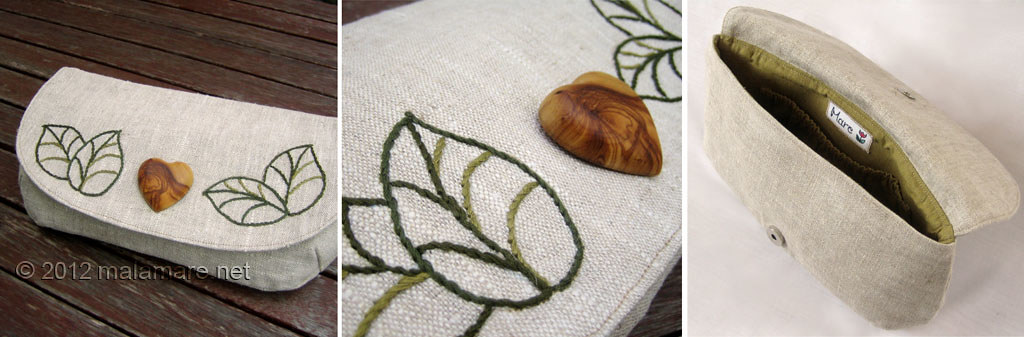 natural linen fabric clutch bag with olive wood heart and hand embroidered leaves motif inside view and details