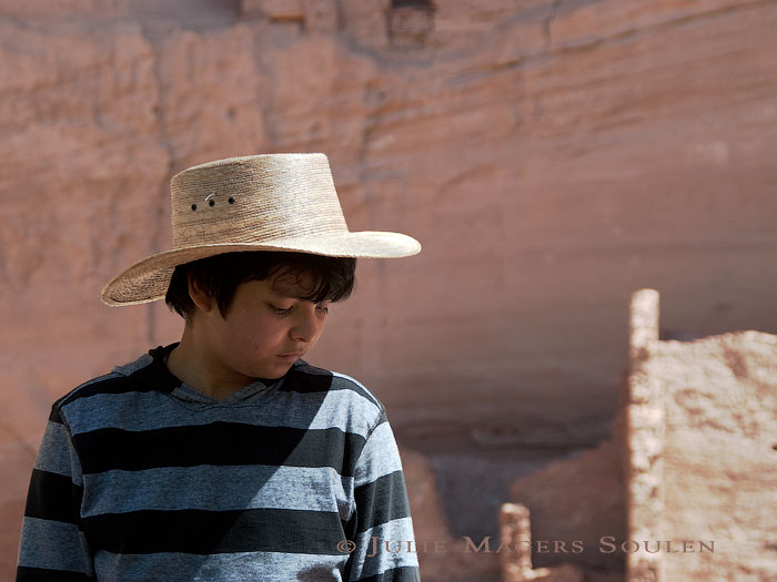 A native American boy gazes pensively at the ground