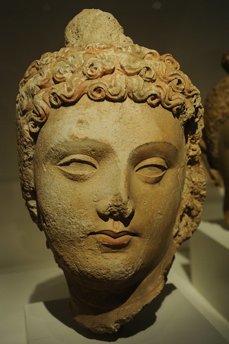 Face of Lord Buddha, head of curly hair, lips, almond shaped eyes, Pakistan or Afghanistan, Gandharan region, 4th/6th century, stucco with traces of pigment,  Art Institute of Chicago, Illinois, USA by Wonderlane