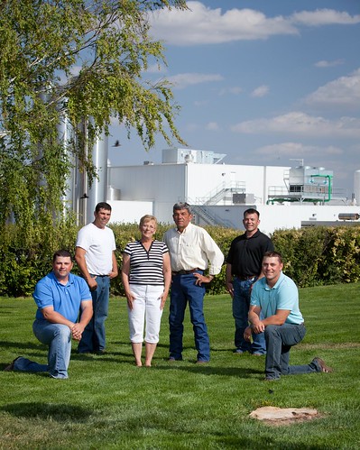 The McCarty family moved to the plains of western Kansas to allow their four sons to fulfill their dairy farming destiny. The first stage of a multi-year collaboration with The Dannon Company is in the background: a milk processing and condensing plant that helps to reduce the carbon footprint of the yogurt. Pictured left to right are Mike, Clay, Judy, Tom, David and Ken McCarty.  (Submitted photo.  Used with permission).