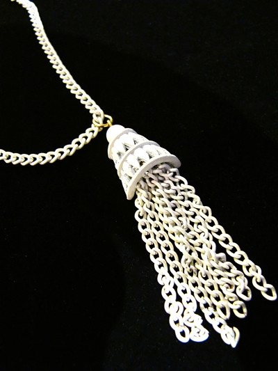 Swing it with this white enamel vintage tassel necklace