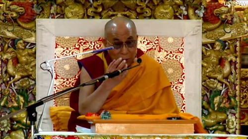 How to get rid of attachment and distructive emotions, His Holiness the Great 14th Dalai Lama, teaching live over the Internet Introductory Buddhist Teachings, Tibetan Buddhist monk, ornate symbolic throne, Main Tibetan Temple in Dharamsala, India by Wonderlane