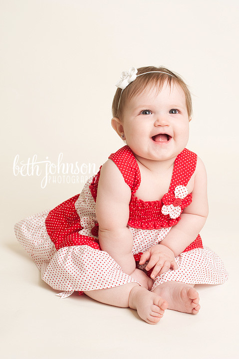 baby girl in red and white polka dots in photography studio tallahassee