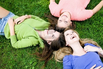 10427465-three-girls-lying-on-the-grass
