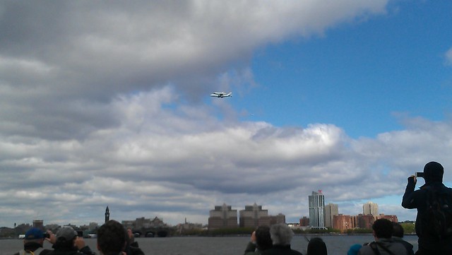 Onlookers on Pier 45 watch Space Shuttle Enterprise fly over the Hudson