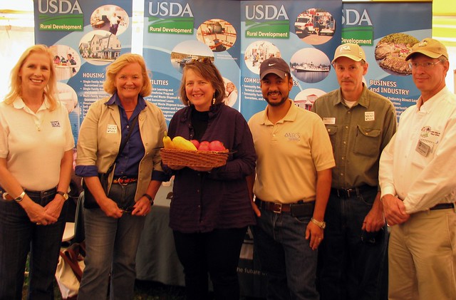 Gathering with USDA Leaders at the Common Ground Fair: USDA Rural Development Maine State Director Virginia Manuel; Maine Congresswoman Chellie Pingree; USDA Deputy Secretary Kathleen Merrigan (holding vegetables from State Office People’s Garden); USDA Natural Resources Conservation Service State Conservationist Juan Hernandez; USDA Farm Service State Executive Director Don Todd III; and USDA National Agricultural Statistics Service Director Gary Keough. 