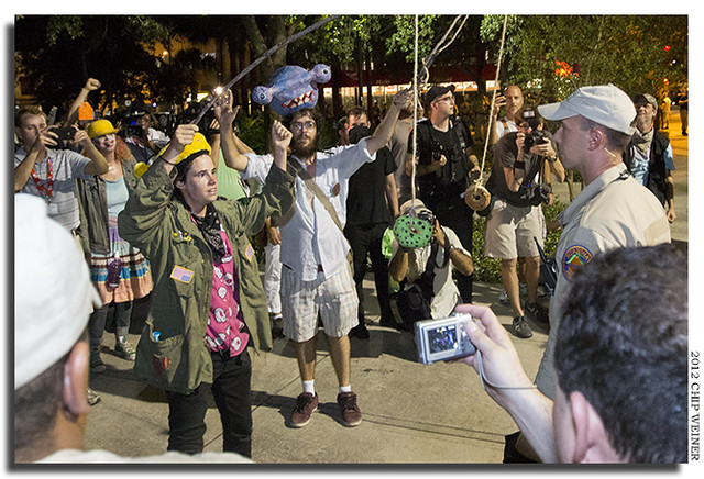 Is it taunting or theater? Nathan Pim and another protester waved doughnuts in front of police officers II