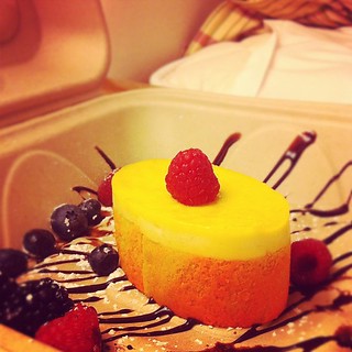 Pineapple mousse/coconut cake dessert to enjoy in bed. They decorated the takeout box!