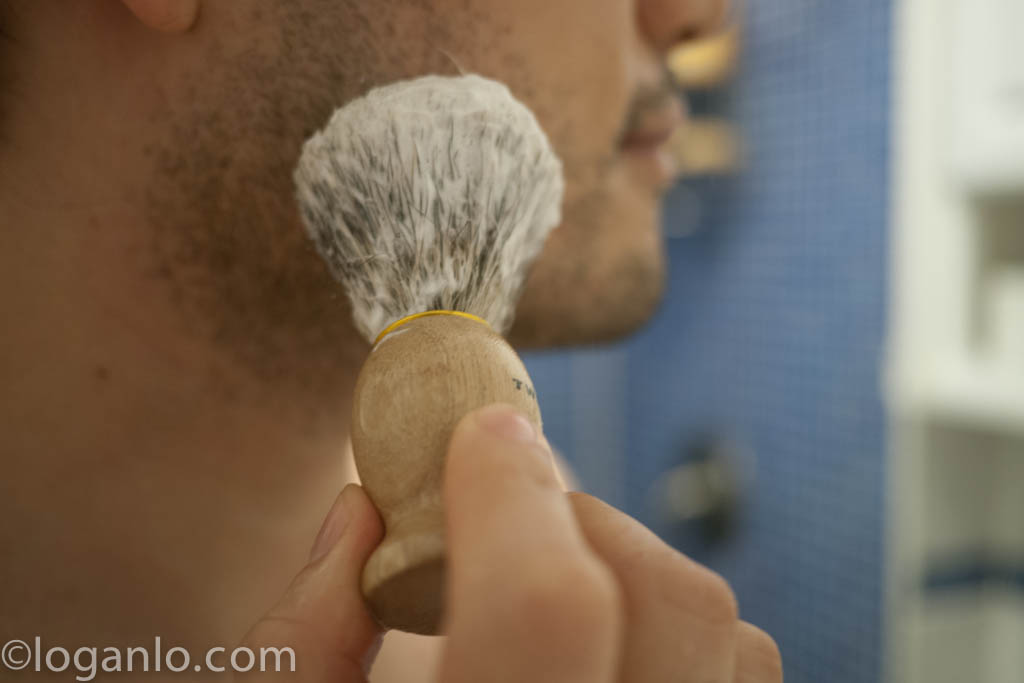 Using a shave brush to lather up the face