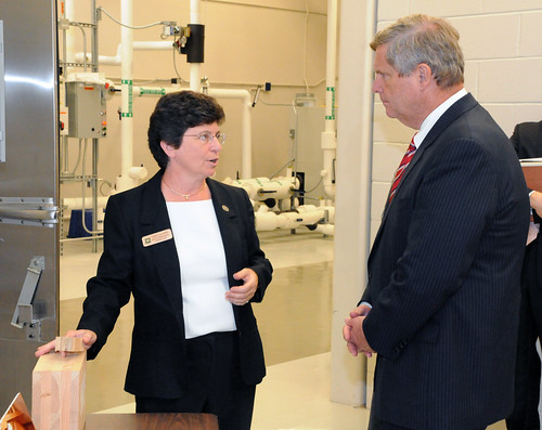 Research Microbiologist Carol Clausen discusses wood durability and protection research with Agriculture Secretary Tom Vilsack during his visit to the Forest Products Laboratory.