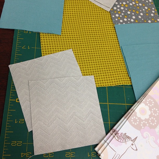 Pieces cut for my first-ever quilt block! (with @yummygoods for note-taking) It was a straight split on which grouping folks liked. I ended up going with the left one in the previous picture. Ready to start sewing. #quilting