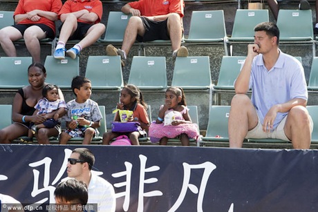 September 27th, 2012 - Yao Ming sits in the stands next to small children as he watches is Shanghai Sharks beat Singapore