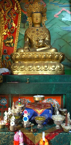 Shri Vajrasattva as religious royality, a Buddha with traditional adornments and jewels, crown, neckplate, shrine set up with tormas and nectar offerings for an intiation, Sakya Lamdre, Tharlam Monastery of Tibetan Buddhism, Boudha, Kathmandu, Nepal by Wonderlane