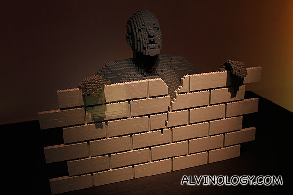 Brick man behind a brick wall 