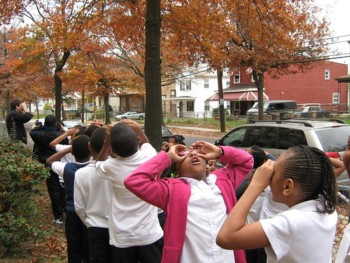  Local children from the Paul Public Charter School in Washington, D.C., take to the streets pretending to use binoculars in search of their urban forest. Washington D.C. was one of the top cities highlighted in the NY Times “Top 10 Urban Forests”.