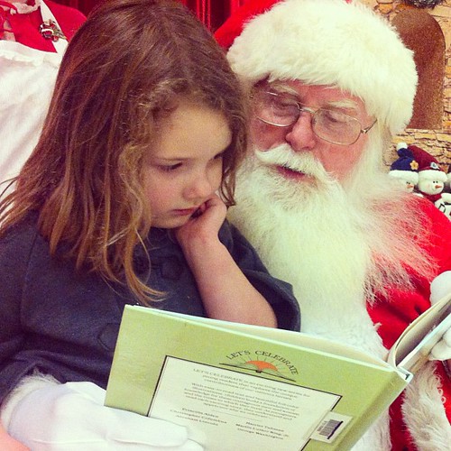 You guys, my heart melted. She took Santa a book and he read it with her. #holidaybliss