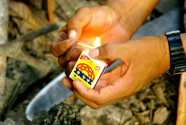 lighting fire with match in the amazon