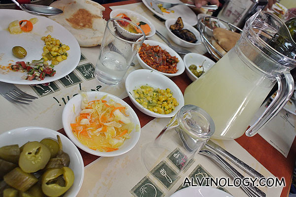 Assorted pickles, humus, pita bread and a pitcher of juice was served first 