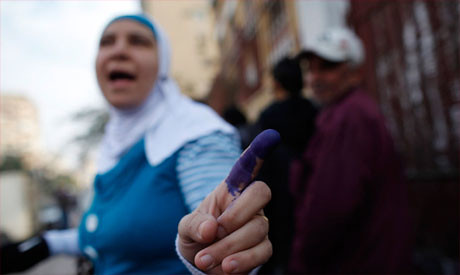 Egyptian voter shows blue finger during poll on draft constitution. The opposition National Salvation Front says the vote was rigged and that 66 percent voted no. by Pan-African News Wire File Photos