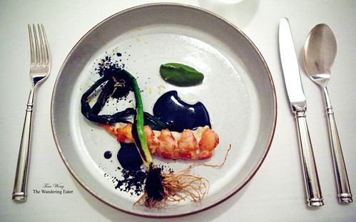 Poached lobster with charred leeks, black onion, and shellfish bisque