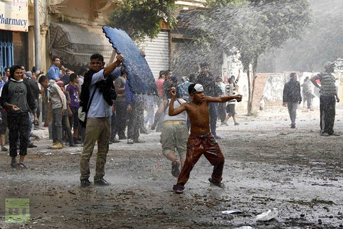 A young Egyptian protester throws a stone at anti riot policemen during clashes in the Cairo's Mohammed Mahmoud street on November 22, 2012. Egyptian protesters clashed with the police for a forth day. by Pan-African News Wire File Photos