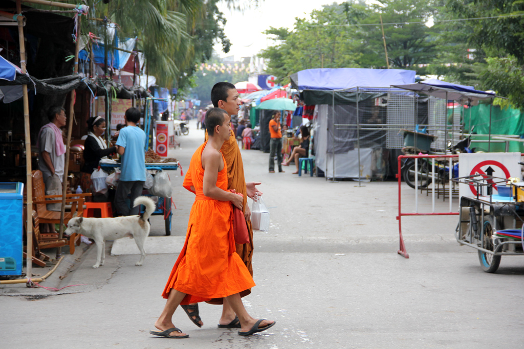 A group of monks out walking around the market