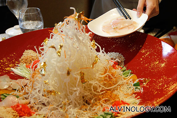 Adding in the most important ingredient, the Yu Sheng 