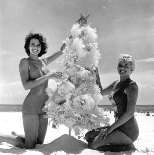 Meriam De Shazo and Kenna Morris modeling with a Christmas Tree on Pensacola Beach by State Library and Archives of Florida