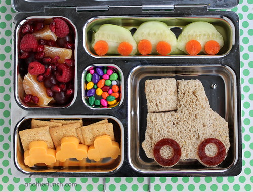 image of lunch bento box with car and truck shaped sandwich, cheese, and cucumbers