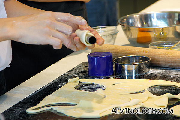 Wrapping the dough around a metal tube for frying 