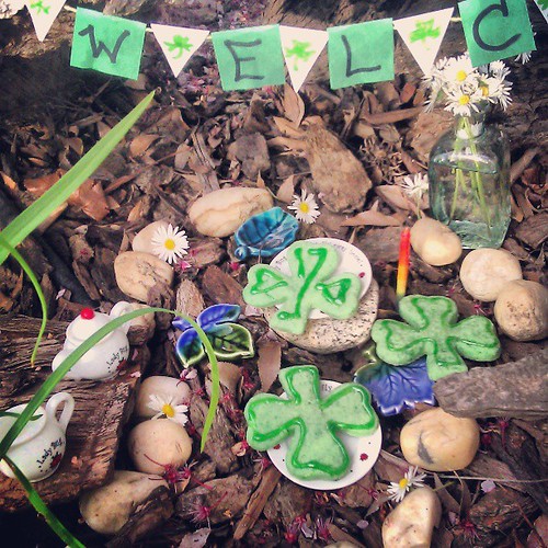 Leprechaun party is all ready for the Wee Folk. We have shamrock cookies, milk, and honey for them. Asher brought some pretty flowers to make it beautiful, and we have a wee banner that says "Welcome."
