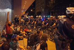 An occupier raises his fist in protest as Philadelphia PD bike unit kettles and arrests entire march during Occupy's National Gatherine
