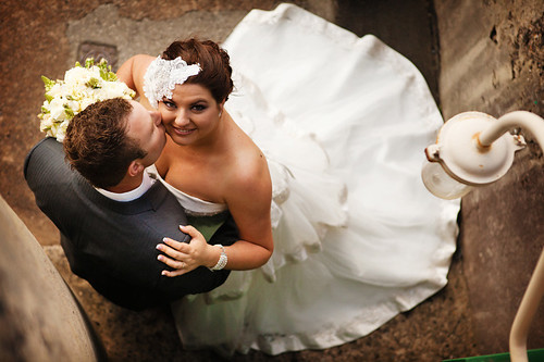 Groom kissing the smiling bride.