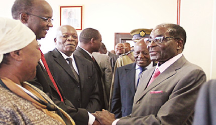 President Mugabe greets Zanu-PF Politburo member Cde Jonathan Moyo while Cdes Sandi Moyo, Charles Tawengwa and Didymus Mutasa look on before a Politburo meeting at the party’s national headquarters in Harare on April 11, 2013. by Pan-African News Wire File Photos