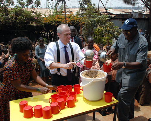 Ambassador Godec helps the Stara Rescue Center school founder and director, Josephine Mumo (left), and the World Food Program country director, Ronald Sibanda, prepare meals for the center’s students. The center is just one of the beneficiaries of the USDA-funded program implemented by WFP in Kenya where U.S.-grown food feeds 650,000 children at more than 2,000 schools. (Courtesy Photo)