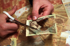 Igor Arinich cutting banknote