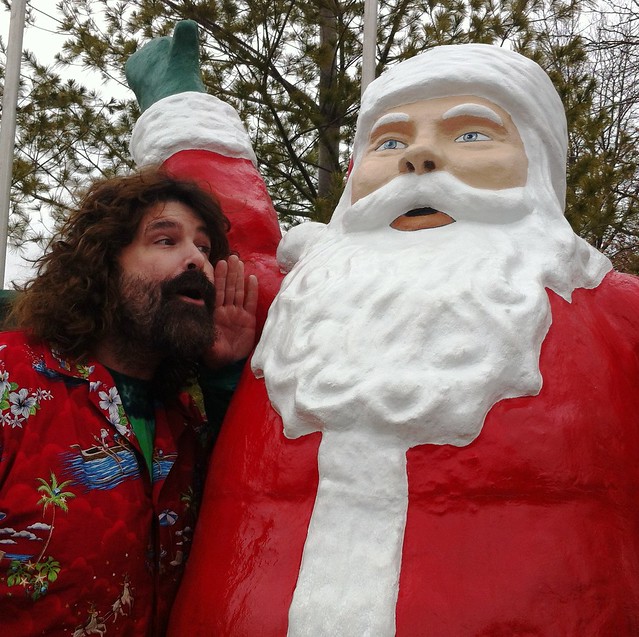 Mick Foley whispers in Santa's ear